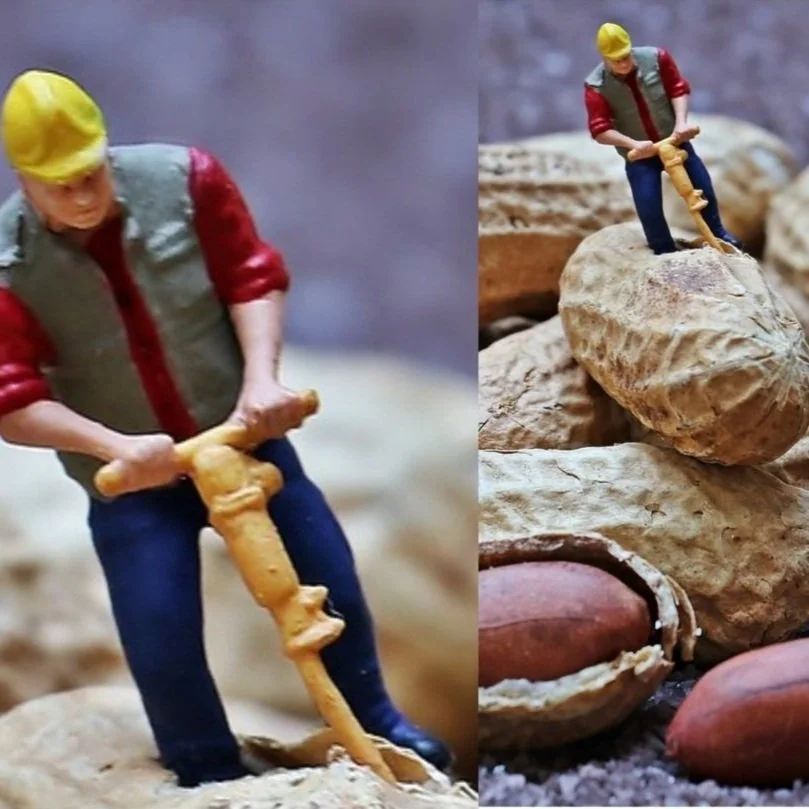 Toy construction workers with a jackhammer and a shovel, at work on a pile of peanuts.
